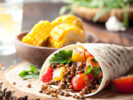 Vegan tortilla wrap, roll with grilled vegetabes, lentil, corn cob.